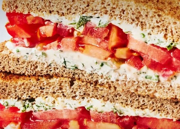 Delicious classic tomato sandwich with fresh tomatoes and creamy spread