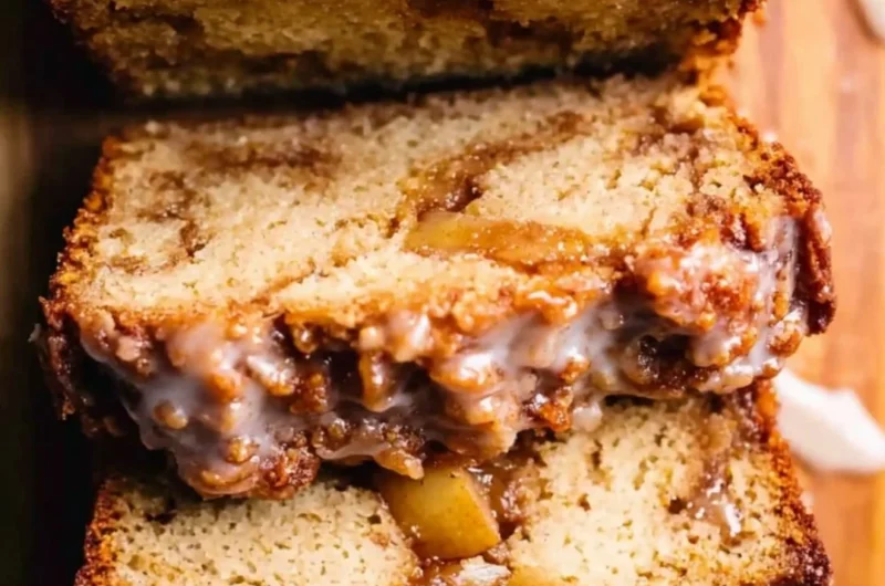 Amish apple fritter bread with apple chunks and glaze on a wooden table