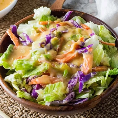 Bottle of Benihana Ginger Salad Dressing on a colorful salad