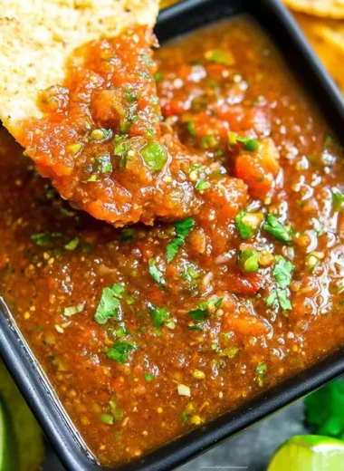 Freshly made blender salsa in a glass bowl with colorful ingredients