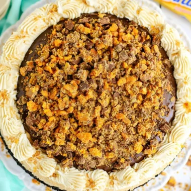Delicious Butterfinger Cheesecake topped with crushed Butterfinger candy