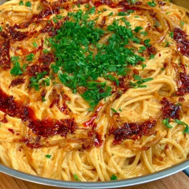 Creamy caramelized onion pasta dish with herbs and cheese