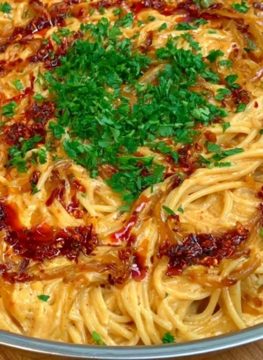 Creamy caramelized onion pasta dish with herbs and cheese