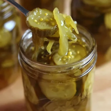 Homemade Grandma's bread and butter pickles in a glass jar with spices