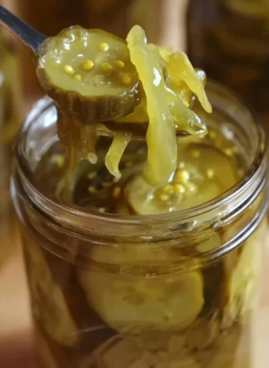 Homemade Grandma's bread and butter pickles in a glass jar with spices