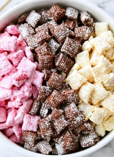Delicious Neapolitan Puppy Chow with chocolate, strawberry, and vanilla toppings.