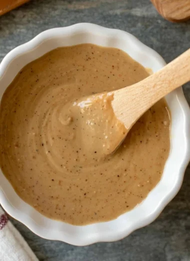 Bowl of quick miso sauce with ingredients on a wooden table