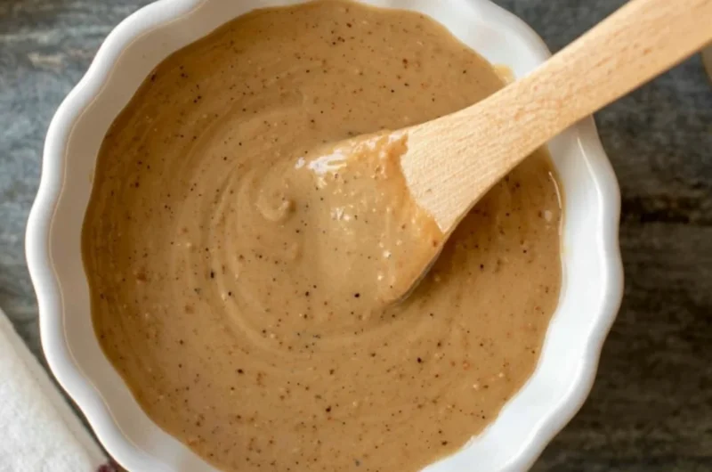Bowl of quick miso sauce with ingredients on a wooden table