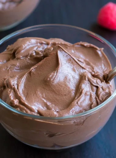 Delicious vegan chocolate pudding served in a bowl topped with berries
