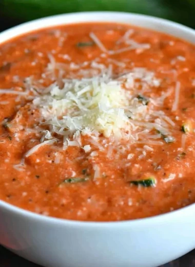 Delicious Zucchini Tomato Soup garnished with fresh basil and served in a bowl.