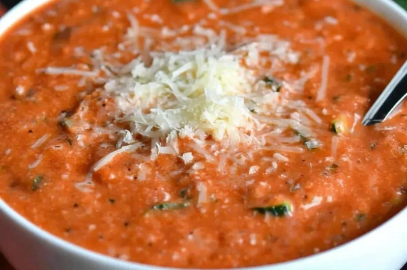 Delicious Zucchini Tomato Soup garnished with fresh basil and served in a bowl.