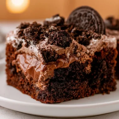 A delicious chocolate dirt cake decorated with gummy worms and crushed cookies.