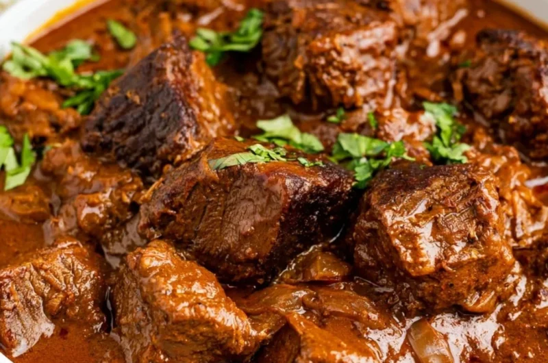 Delicious bowl of cozy Beef Vindaloo garnished with fresh herbs and spices