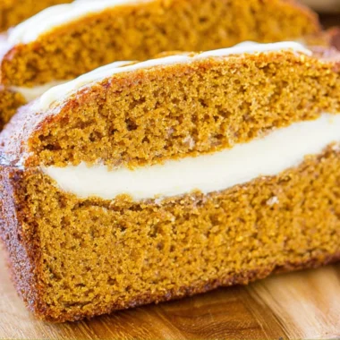 Cozy pumpkin bread with cream cheese drizzled on top