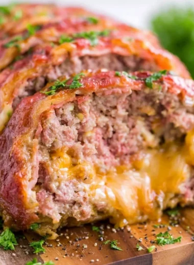 Deliciously smoked meatloaf served on a rustic wooden table