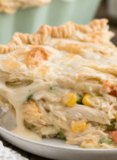 Delicious semi-homemade chicken pot pie served on a rustic wooden table.