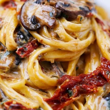 Sun-Dried Tomato Mushroom Pasta served in a bowl, garnished with fresh herbs.