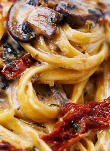 Sun-Dried Tomato Mushroom Pasta served in a bowl, garnished with fresh herbs.