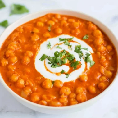 Vegan chickpea curry served in a bowl with spices and herbs