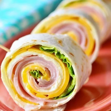 Cozy ham and cheese pinwheels ready to enjoy as a tasty snack or appetizer.