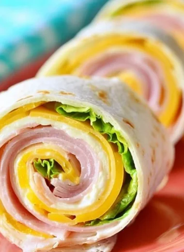 Cozy ham and cheese pinwheels ready to enjoy as a tasty snack or appetizer.
