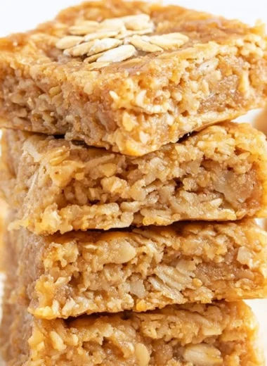 Delicious homemade soft and chewy apple oatmeal bars on a wooden table