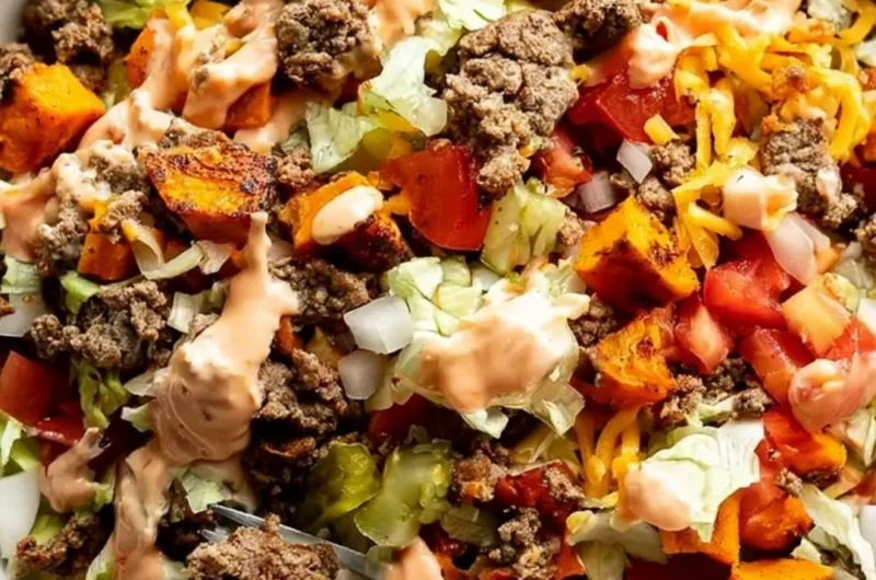 Delicious sweet potato burger bowl topped with fresh vegetables and spices.